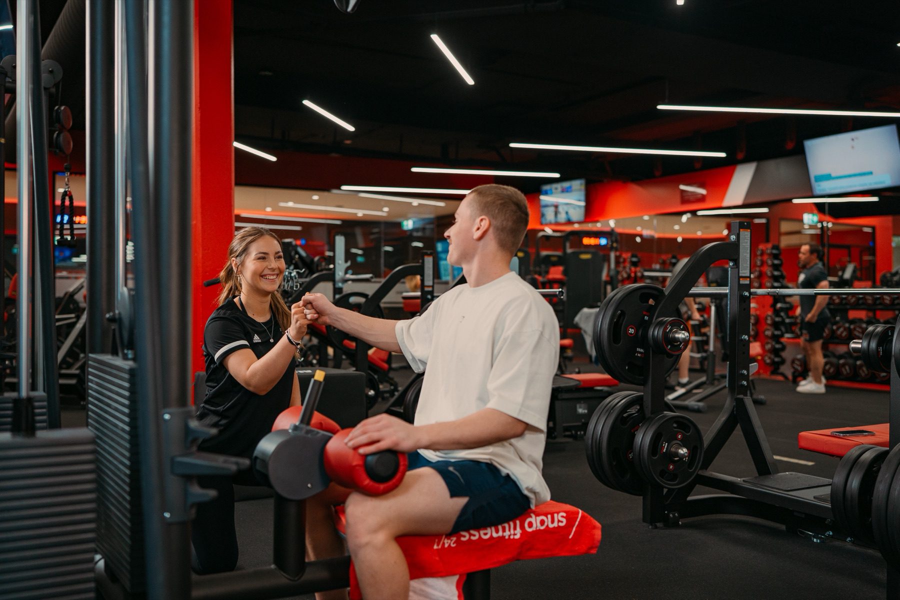 A member training on a sled inside a Snap Fitness club